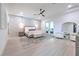 Spacious main bedroom with a decorative wall, ceiling fan, a sitting area, and balcony access at 4815 W Sunset Blvd, Tampa, FL 33629