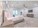 Bright main bedroom featuring a decorative accent wall, ceiling fan and a flat screen television at 4815 W Sunset Blvd, Tampa, FL 33629