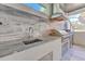 Outdoor kitchen featuring granite counters, stainless steel grill, and vent hood perfect for al fresco dining at 4815 W Sunset Blvd, Tampa, FL 33629