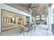 Expansive patio showcasing an outdoor dining area, outdoor kitchen, pool table, and views into the living area at 4815 W Sunset Blvd, Tampa, FL 33629