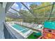 A screened-in pool with a playground area, offering a fun and secure outdoor space for Gathering enjoyment at 4815 W Sunset Blvd, Tampa, FL 33629