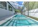 An expansive screened-in pool with a built-in spa and plenty of space for lounging and recreation at 4815 W Sunset Blvd, Tampa, FL 33629