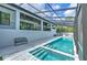 A stunning pool with multiple levels, complemented by a screened enclosure, for a refreshing and private swimming experience at 4815 W Sunset Blvd, Tampa, FL 33629