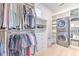 Large walk-in closet with custom shelving, drawers, and built-in laundry machines at 4815 W Sunset Blvd, Tampa, FL 33629