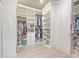 Spacious walk-in closet with custom shelves, cabinets, drawers, and hanging racks at 4815 W Sunset Blvd, Tampa, FL 33629