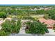 An aerial view of a well-maintained single-story home surrounded by lush landscaping and mature trees at 4912 Sabal Lake Cir, Sarasota, FL 34238
