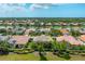Aerial view of a single-Gathering home with a tile roof surrounded by mature landscaping and a lake view at 4912 Sabal Lake Cir, Sarasota, FL 34238