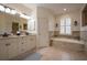 Bright bathroom with double vanity, soaking tub, and natural light at 4912 Sabal Lake Cir, Sarasota, FL 34238