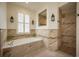 Inviting bathroom featuring a soaking tub with decorative tile and bright lighting at 4912 Sabal Lake Cir, Sarasota, FL 34238