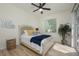 Bright bedroom featuring a ceiling fan, neutral walls, and light wood flooring at 4912 Sabal Lake Cir, Sarasota, FL 34238