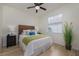 Cozy bedroom with a wood-look headboard, neutral walls, and a ceiling fan at 4912 Sabal Lake Cir, Sarasota, FL 34238