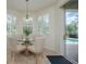 Sunlit breakfast nook with views of the pool area through sliding glass doors at 4912 Sabal Lake Cir, Sarasota, FL 34238