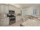 The kitchen boasts stainless steel appliances, granite countertops, and a stylish backsplash at 4912 Sabal Lake Cir, Sarasota, FL 34238