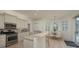 Open kitchen with stainless steel appliances and granite countertops, seamlessly connects to a dining area at 4912 Sabal Lake Cir, Sarasota, FL 34238
