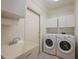 Functional laundry room with sink, cabinetry, and a washer and dryer at 4912 Sabal Lake Cir, Sarasota, FL 34238