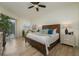 Comfortable bedroom featuring wood floors, a ceiling fan, and sliding glass doors at 4912 Sabal Lake Cir, Sarasota, FL 34238