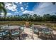 Outdoor patio seating is set against the backdrop of a serene lake at 4912 Sabal Lake Cir, Sarasota, FL 34238