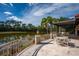 Outdoor patio with seating overlooks a beautiful lake view at 4912 Sabal Lake Cir, Sarasota, FL 34238