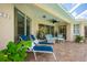 Rear patio with ceiling fan and tropical landscaping at 4912 Sabal Lake Cir, Sarasota, FL 34238