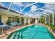 Sparkling swimming pool surrounded by patio, tropical landscaping and comfortable patio furniture at 4912 Sabal Lake Cir, Sarasota, FL 34238