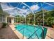 Sparkling swimming pool surrounded by mature, lush landscaping at 4912 Sabal Lake Cir, Sarasota, FL 34238