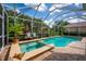 Screened pool area featuring a pool and spa at 4912 Sabal Lake Cir, Sarasota, FL 34238