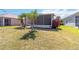 View of backyard with lush greenery and a screened-in lanai attached to the home at 5227 Aqua Breeze Dr, Bradenton, FL 34208