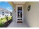 Home's front door and entry way, decorated with hanging ornaments and butterfly decorations at 5227 Aqua Breeze Dr, Bradenton, FL 34208