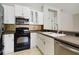 Modern kitchen featuring white cabinetry, stainless steel appliances, and modern countertops at 5227 Aqua Breeze Dr, Bradenton, FL 34208