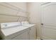 Laundry room with washer, dryer, door and overhead wire shelving at 5227 Aqua Breeze Dr, Bradenton, FL 34208