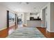 Open-concept living room featuring hardwood floors, neutral paint, and large windows for natural light at 5227 Aqua Breeze Dr, Bradenton, FL 34208