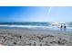 A sunny day at the beach, with ocean views, sand, and people enjoying the water at 532 Yale Rd, Venice, FL 34293