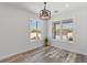 Bright dining area with a modern light fixture and large windows overlooking the yard at 532 Yale Rd, Venice, FL 34293