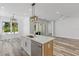 Open kitchen with an island, stainless steel appliances, and view of backyard patio at 532 Yale Rd, Venice, FL 34293