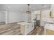 Open kitchen with an island, stainless steel appliances, and modern light fixtures at 532 Yale Rd, Venice, FL 34293