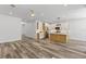 Bright, open-concept kitchen with white cabinets, stainless steel appliances, and wood grain floors at 532 Yale Rd, Venice, FL 34293