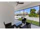 Spacious, covered patio with wicker seating and a view of the fenced backyard at 532 Yale Rd, Venice, FL 34293