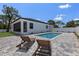 Backyard features a rectangular pool, brick pavers and lounge chairs at 532 Yale Rd, Venice, FL 34293