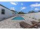Clean backyard featuring pool, brick patio, chairs, and white fence at 532 Yale Rd, Venice, FL 34293