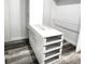 Custom walk-in closet with white storage, shelving and drawers with glass fronts at 532 Yale Rd, Venice, FL 34293