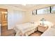 Cozy bedroom featuring a twin bed, closet, and sunny window, complete with neutral tones and hardwood floors at 5362 Huntingwood Ct # 16, Sarasota, FL 34235