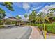 Welcoming clubhouse entrance with a covered drop-off and well-maintained landscaping at 5362 Huntingwood Ct # 16, Sarasota, FL 34235