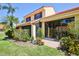 Charming home exterior with manicured lawn, vibrant flower beds, and a private patio. Ideal outdoor living space at 5362 Huntingwood Ct # 16, Sarasota, FL 34235