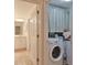 Bright laundry area with modern washer and dryer, hidden by a cheerful plaid curtain for a clean, organized look at 5362 Huntingwood Ct # 16, Sarasota, FL 34235