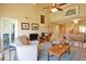 Spacious living room with a vaulted ceiling, tile floors, and a sliding glass door to a patio at 5362 Huntingwood Ct # 16, Sarasota, FL 34235