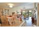 Cozy living room featuring tile floors, a vaulted ceiling, and a sliding glass door to the outside at 5362 Huntingwood Ct # 16, Sarasota, FL 34235
