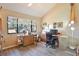 Well-lit office with modern desk and shelving, complemented by a large window, ideal for a productive workspace at 5362 Huntingwood Ct # 16, Sarasota, FL 34235