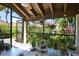 Enclosed patio filled with lush plants, offering a serene view of the surrounding community and beautiful hanging plants at 5362 Huntingwood Ct # 16, Sarasota, FL 34235