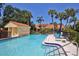 Sparkling community pool area with lounge chairs and manicured landscaping, perfect for relaxing and enjoying the outdoors at 5362 Huntingwood Ct # 16, Sarasota, FL 34235