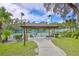 Tennis court rest area offers a covered space with seating amidst lush landscaping at 5362 Huntingwood Ct # 16, Sarasota, FL 34235